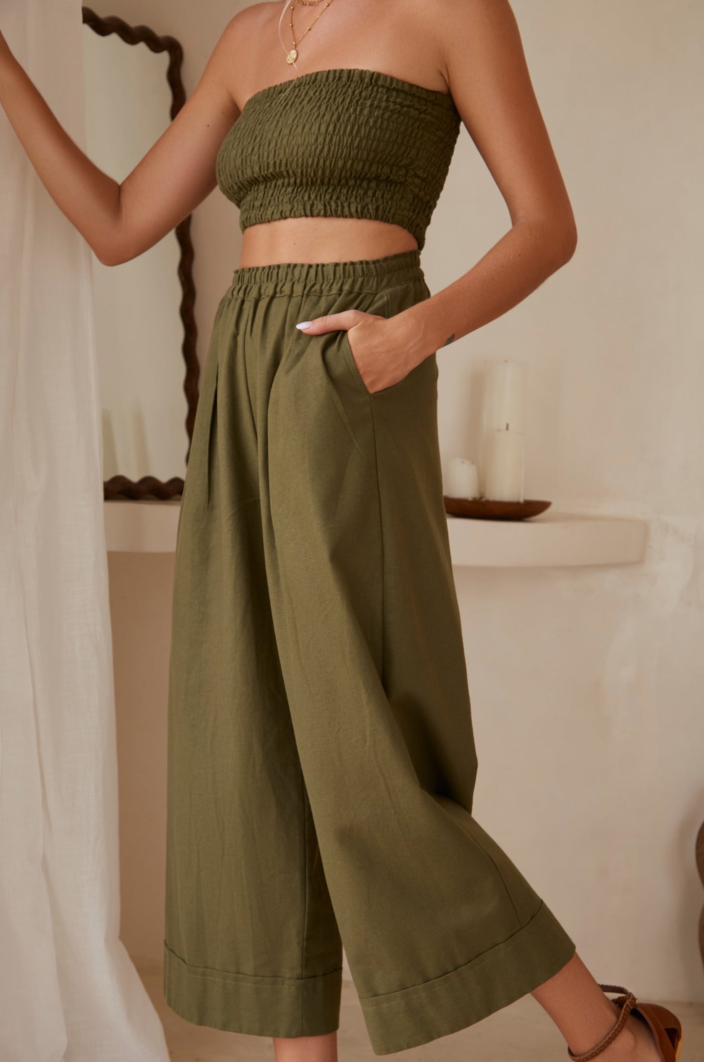 Strapless smocked bandeau styled with wide leg linen trousers