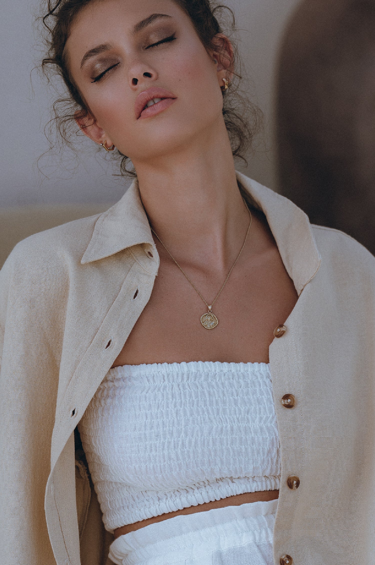 Strapless alabaster smocked bandeau styled with wide leg linen trousers