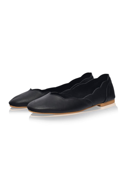 Almond toe black leather ballet flats with scalloped edges