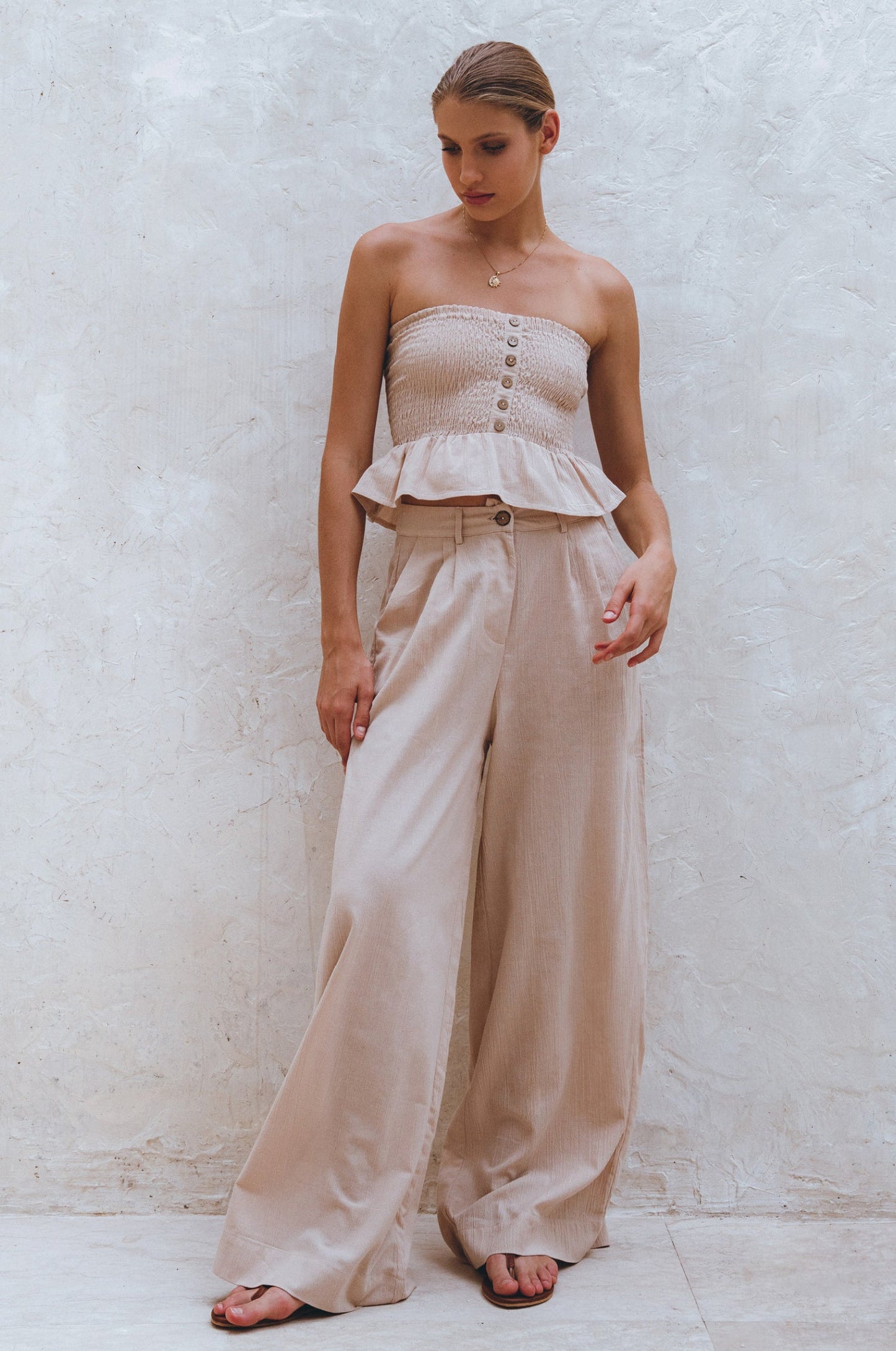 Raya pin-tucked linen trousers in crinkle sand by Sevine
