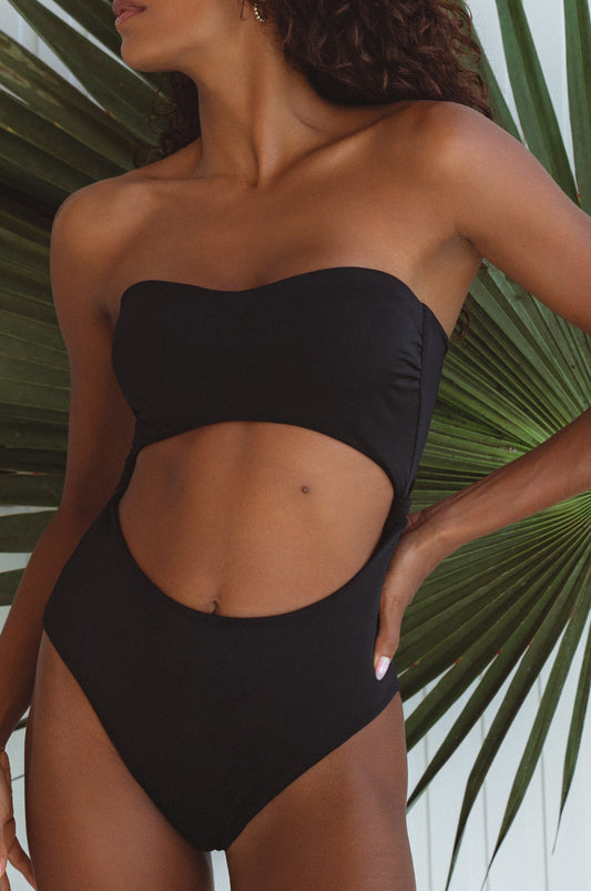Black strapless one-piece swimsuit with front waist cut-out and high-cut leg